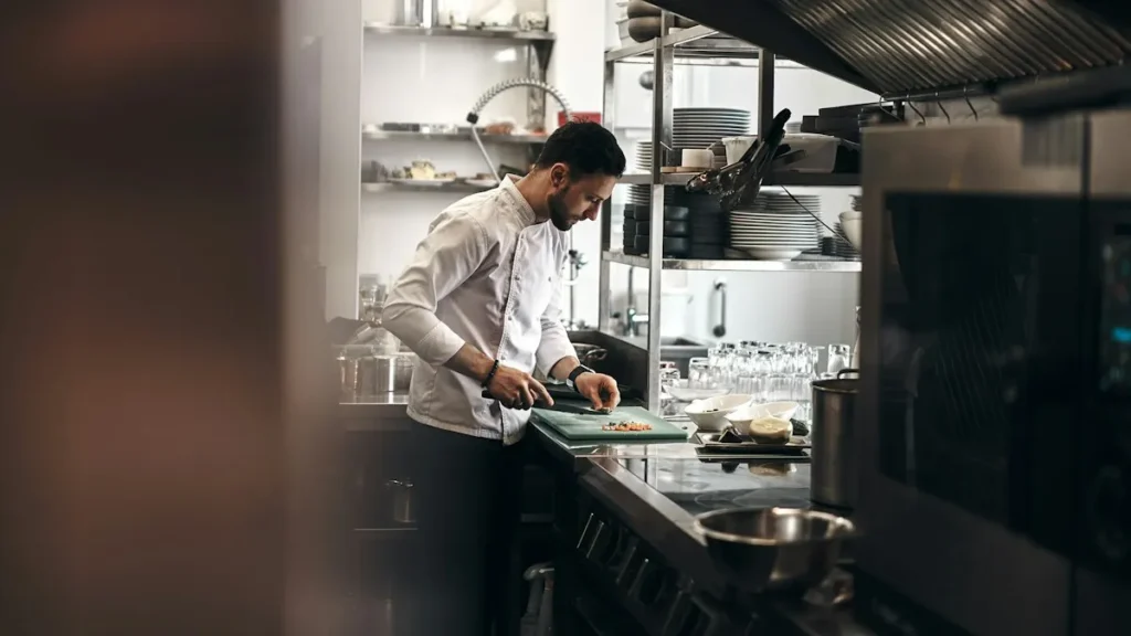 A Great Chef’s Knife Does Not Have to Cost More Than Fifty Dollars Chef cutting vegetables with the best chef knife under 50